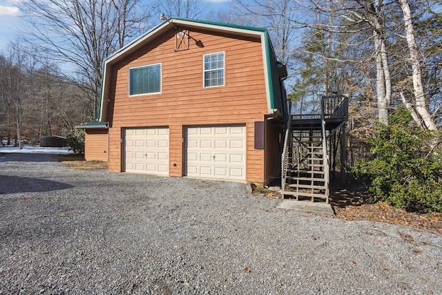 view of home's exterior featuring stairs, driveway, and an attached garage