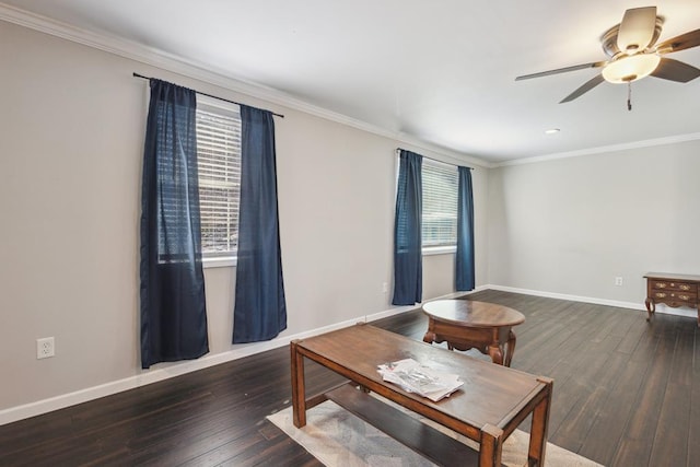 living area with ornamental molding, wood-type flooring, ceiling fan, and baseboards