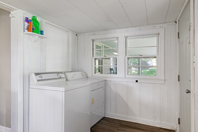 clothes washing area with dark wood-style floors, laundry area, and washing machine and dryer