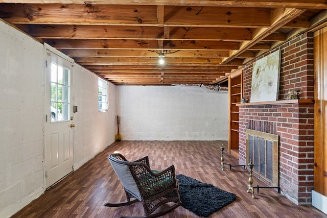 below grade area featuring a fireplace and wood finished floors