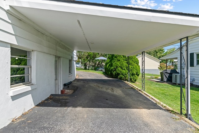 view of parking / parking lot featuring a carport