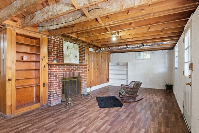 basement featuring a brick fireplace and wood finished floors