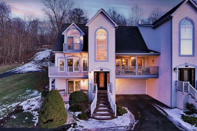 view of front facade featuring a garage and a balcony