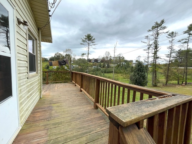 wooden deck featuring a yard