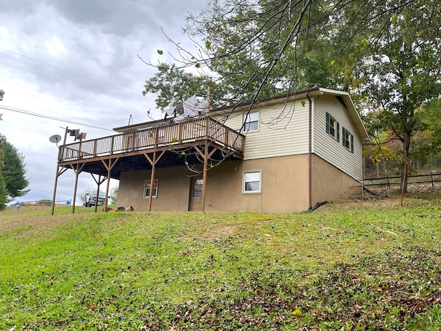 rear view of property with a yard and a deck