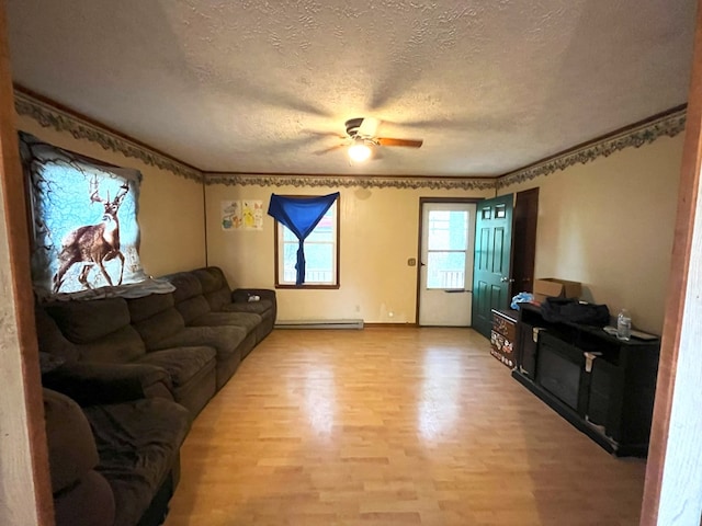 living room featuring a baseboard heating unit, light hardwood / wood-style flooring, a textured ceiling, and ceiling fan