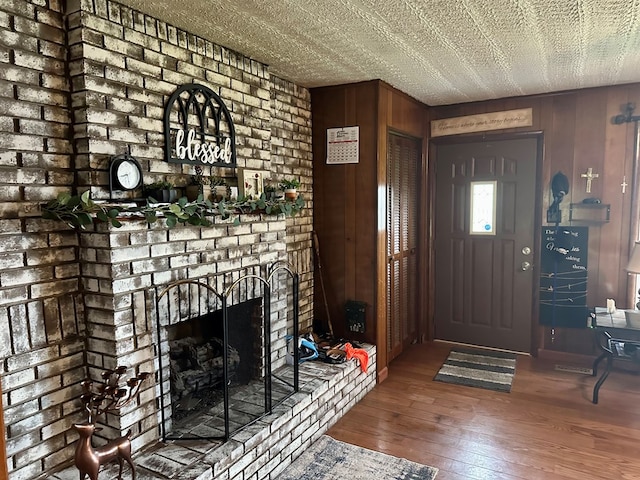118 2nd Ave, Richlands, VA 24641 - foyer entrance featuring wood walls, wood-type flooring, and a brick fireplace