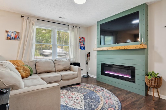 156 Ridgecrest St, Bluefield, VA 24605 - living area with wood finished floors, baseboards, a textured ceiling, and a large fireplace
