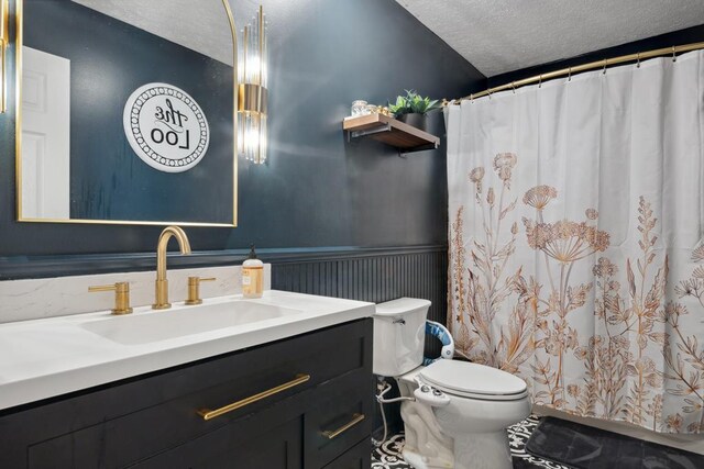156 Ridgecrest St, Bluefield, VA 24605 - full bathroom with a textured ceiling, toilet, wainscoting, vanity, and a shower with curtain