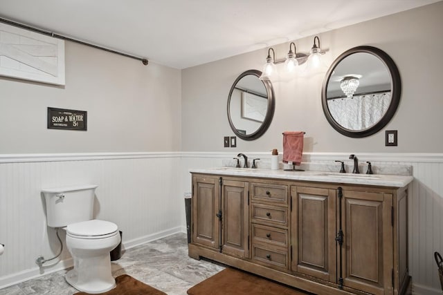 156 Ridgecrest St, Bluefield, VA 24605 - bathroom featuring a wainscoted wall, toilet, double vanity, and baseboards