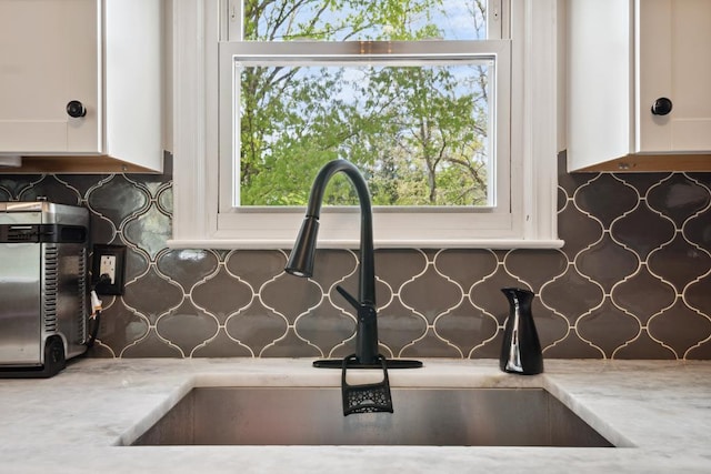 156 Ridgecrest St, Bluefield, VA 24605 - kitchen view of a sink, decorative backsplash, and white cabinets