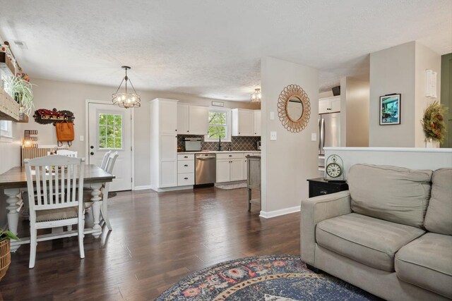 156 Ridgecrest St, Bluefield, VA 24605 - living area with dark wood-type flooring, a textured ceiling, baseboards, and a chandelier