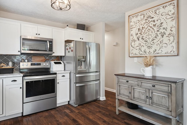 156 Ridgecrest St, Bluefield, VA 24605 - kitchen featuring appliances with stainless steel finishes, dark wood-style floors, white cabinetry, tasteful backsplash, and a textured ceiling