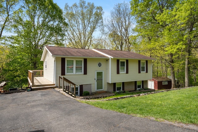 156 Ridgecrest St, Bluefield, VA 24605 - bi-level home featuring a front yard, an outdoor structure, roof with shingles, and a storage shed