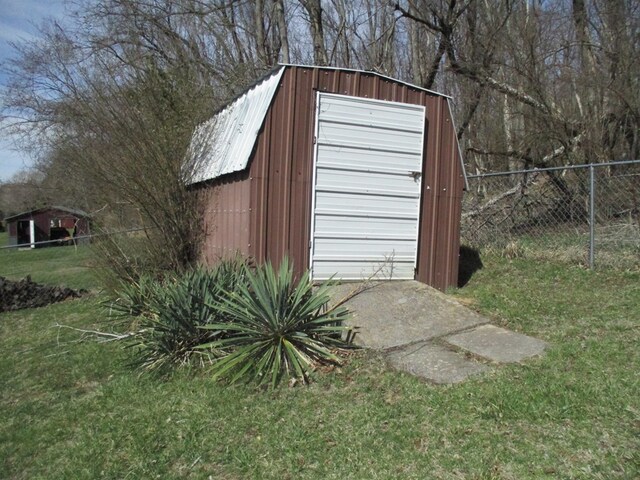 view of outbuilding with an outbuilding and fence
