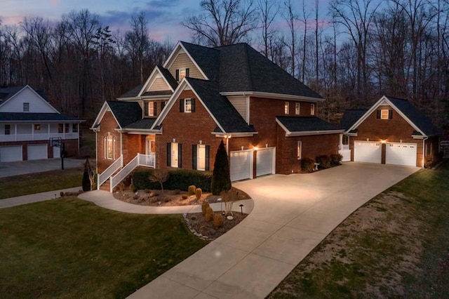 view of front of property featuring a garage, a front yard, concrete driveway, and brick siding