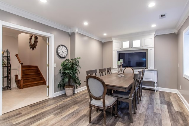 dining space featuring visible vents, stairway, wood finished floors, crown molding, and recessed lighting