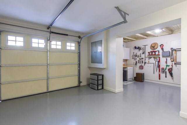 garage with electric panel and baseboards