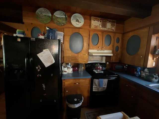 kitchen featuring under cabinet range hood, brown cabinets, and black appliances