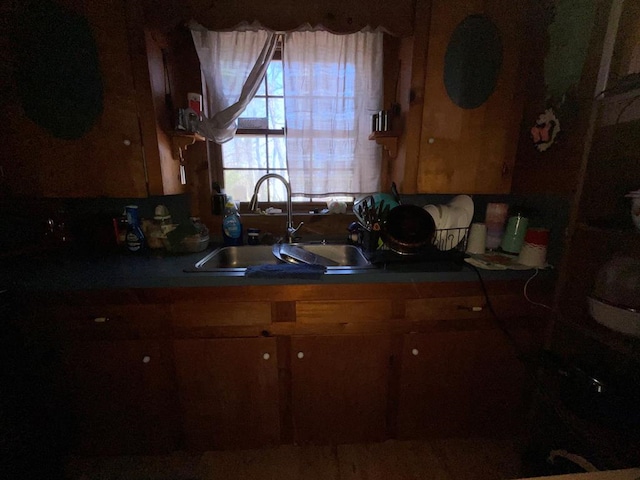 kitchen featuring a sink and brown cabinetry