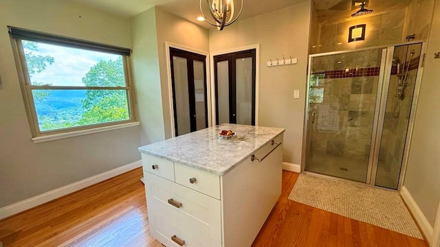 675 Pine Ridge Rd, Wytheville, VA 24382 - bathroom with wood finished floors, a shower stall, plenty of natural light, and a chandelier