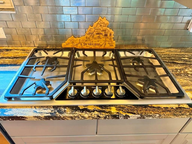 675 Pine Ridge Rd, Wytheville, VA 24382 - kitchen view of dark countertops, stainless steel gas cooktop, and backsplash