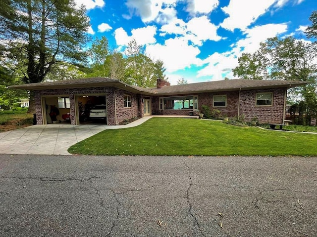 675 Pine Ridge Rd, Wytheville, VA 24382 - view of front of house featuring an attached garage, driveway, brick siding, a chimney, and a front yard