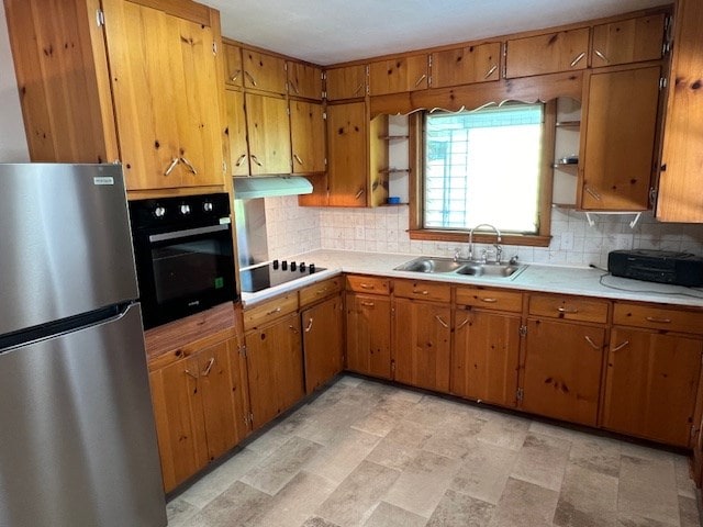 kitchen with sink, decorative backsplash, and black appliances