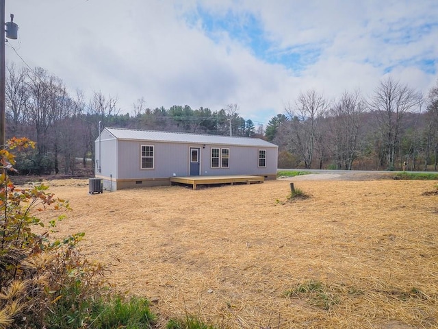 manufactured / mobile home with a wooden deck and cooling unit