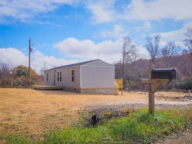 view of home's exterior featuring a wooden deck