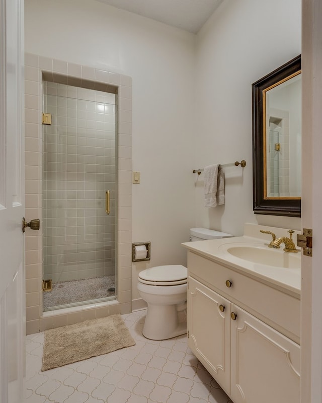 full bathroom with a shower stall, toilet, and vanity