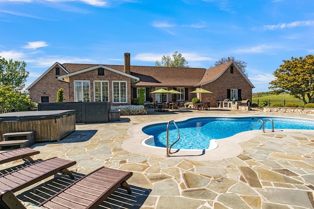 view of pool with fence, a hot tub, a patio, and a fenced in pool
