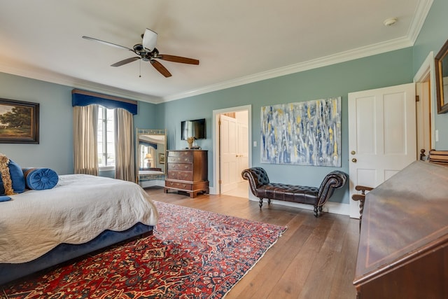 bedroom featuring ceiling fan, baseboards, ornamental molding, and hardwood / wood-style floors