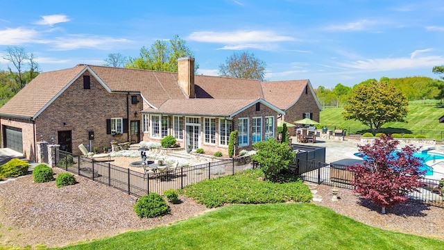 back of property featuring a fenced in pool, a fenced backyard, a patio, and a chimney
