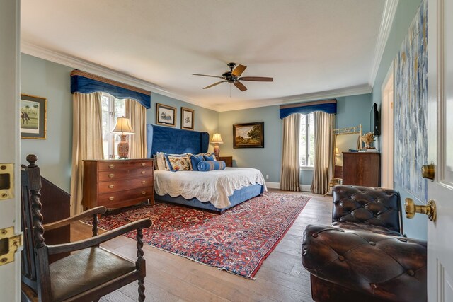 bedroom with hardwood / wood-style flooring and crown molding