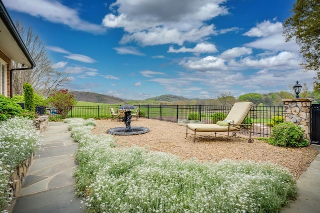 view of yard with fence and a mountain view
