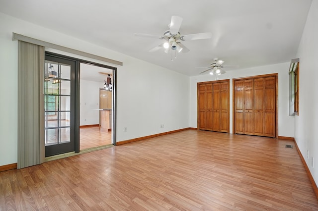 271 Burgan Rd, Pennington Gap, VA 24277 - unfurnished bedroom with light wood-type flooring, baseboards, two closets, and a ceiling fan