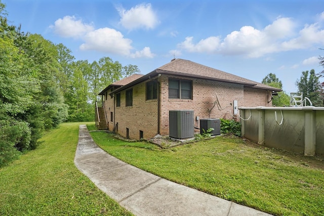 271 Burgan Rd, Pennington Gap, VA 24277 - view of side of home featuring central air condition unit, brick siding, a yard, and roof with shingles