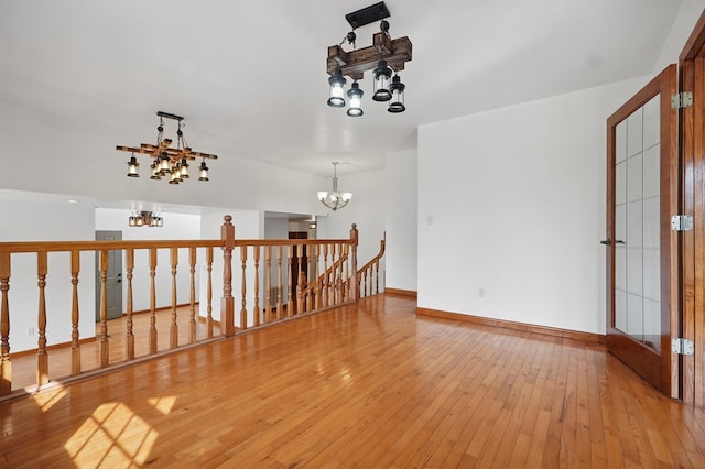 271 Burgan Rd, Pennington Gap, VA 24277 - unfurnished room featuring a chandelier, light wood-type flooring, and baseboards