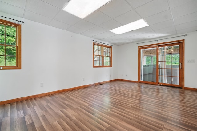 271 Burgan Rd, Pennington Gap, VA 24277 - empty room with wood finished floors, baseboards, plenty of natural light, and a paneled ceiling