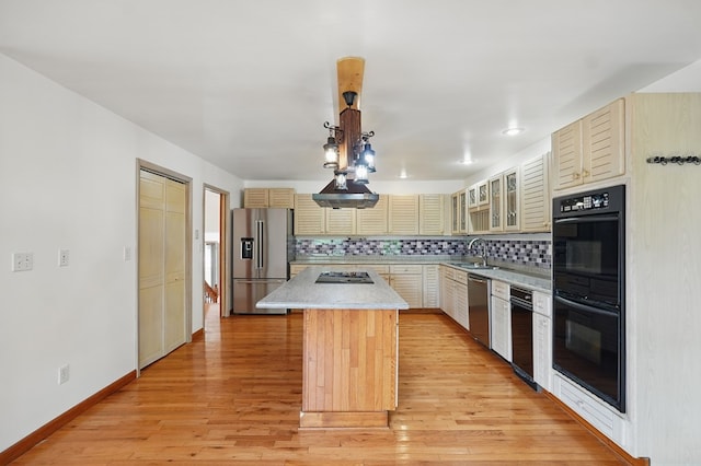 271 Burgan Rd, Pennington Gap, VA 24277 - kitchen featuring appliances with stainless steel finishes, a sink, a center island, cream cabinets, and light countertops
