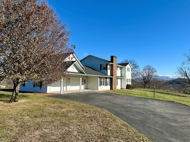 view of front of house featuring a garage and a front yard