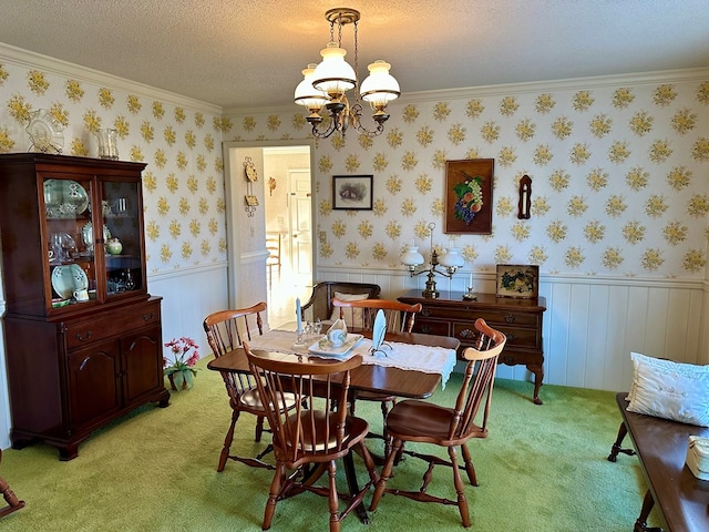 dining space featuring light colored carpet, ornamental molding, and a chandelier