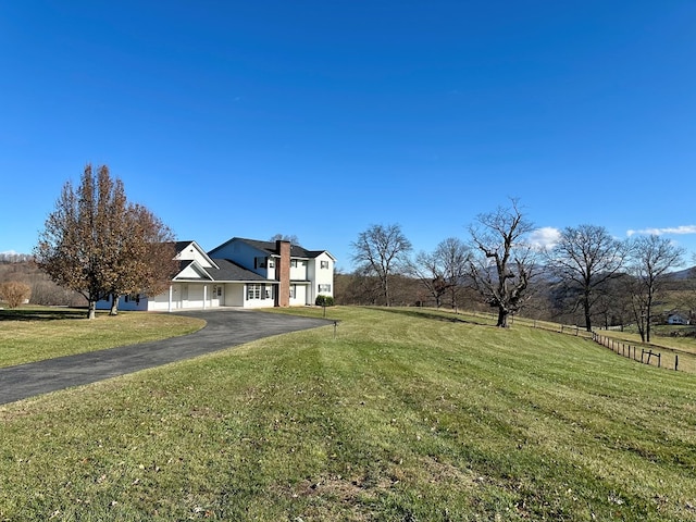 view of front of home featuring a front yard and a rural view