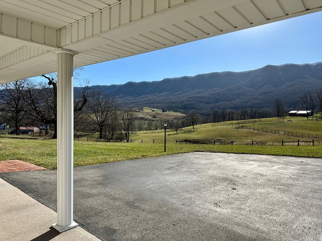 view of patio / terrace with a rural view and a mountain view