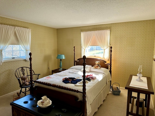 carpeted bedroom featuring multiple windows and a textured ceiling