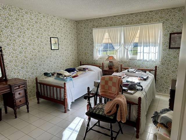 bedroom with light tile patterned floors, multiple windows, and a textured ceiling