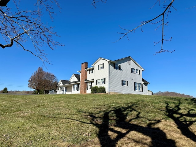 rear view of property with a lawn