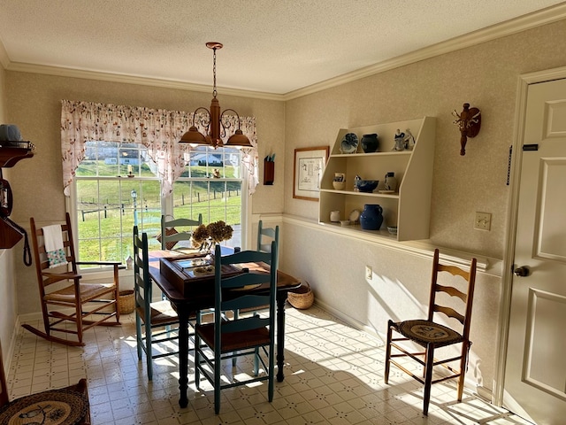 dining room featuring an inviting chandelier, ornamental molding, and a textured ceiling