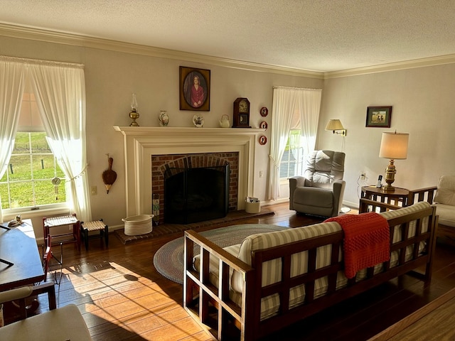 living room with crown molding, hardwood / wood-style floors, a textured ceiling, and a fireplace